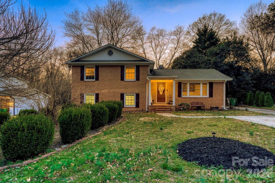 Come visit this must see home nestled in lovely Cotswold! This all brick, split level home sits in the perfect location on a dead end street and just minutes downtown Charlotte! This home features 4 bedrooms, 2.5 upgraded bathrooms, upgraded kitchen, hardwood floors and tile throughout, and a fully encapsulated crawl space and upgraded HVAC! Upon entering the home you'll be welcomed on the foyer attaching the front family room perfect for an office or playroom. Head down the hall to your dining area and upgraded kitchen with granite countertops. Head upstairs and you'll find your primary bedroom with attached en suite and your two upper bedrooms and additional full bathroom. Head back downstairs to your lower level where you'll find your living room with gas fireplace, additional oversized bedroom, laundry room, and 1/2 bathroom. Head outside to your covered back patio and large fenced in back yard. Don't miss this one, it won't last long!