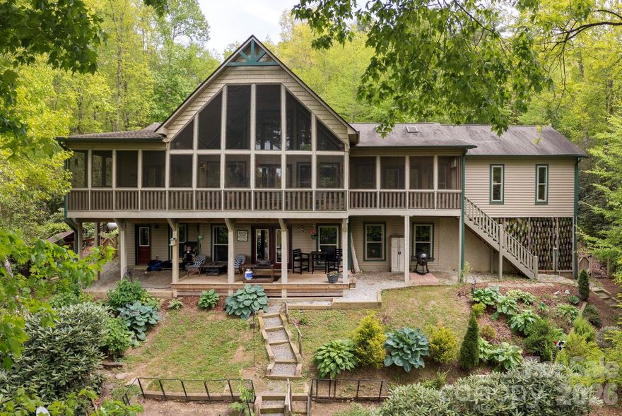 LAKEFRONT living and mountain tranquility in this beautifully crafted 2015 home, ideally situated in Indian Lake Estates. Designed for both comfort and connection to the outdoors, this property offers stunning lake views from nearly every room and a lifestyle that’s hard to match.

The main level features a vaulted great room with a cozy wood-burning fireplace, creating a warm and inviting space for gathering. The open-concept kitchen and dining area showcase granite countertops, double ovens, upscale stainless appliances, and a truly unique artistic touch with custom stained-glass cabinet doors. The spacious primary suite includes private access to the expansive covered and screened porch, along with an en-suite bath and dual closets. An additional bedroom or office and powder room complete the main level.

Stretching across the entire back of the home, the covered and screened porch is the perfect place to enjoy morning coffee, evening sunsets, and peaceful lake views year-round.

The lower-level walk-out offers exceptional flexibility with a private guest suite, full bath, and studio space—ideal for an in-law suite, creative retreat, or potential vacation rental.

Step outside and embrace the lifestyle this property offers. With private lake frontage, enjoy kayaking, fishing, swimming, and relaxing from your own dock. Surrounded by natural, mature landscaping, the property provides a sense of privacy while blending beautifully with its surroundings. Nearby hiking trails add even more opportunity to explore the outdoors.

Additional features include a fenced yard for pets or play and an oversized garage for ample storage and a hot tub to relax and unwind! Full house Generac generator.  Private dock with 4 kayaks.

Whether you're seeking a full-time residence, mountain getaway, or investment opportunity, this lakefront property delivers the best of Western North Carolina living.