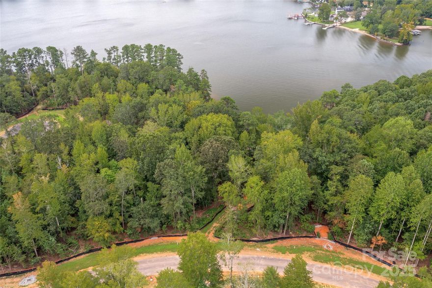 Live the lake life in a new custom-built waterfront home! Homesite 6 in South Carolina features a huge beach and space for your boat dock. Perfect homesite for a basement floor plan. Enjoy south and west lake views from your home & your own sandy beach on Lake Wylie. Build your custom home and add a dock for your lake toys. Add a pool for even more fun. Located in South Carolina but on the border with North Carolina on land that Daniel Stowe owned years ago. This location provides southern views with western perspective on the right side. Buy this homesite and choose when to build with one of McLean's approved builders - no time limit in which to start construction of your home. McLean features a clubhouse, outdoor pool, fitness center, walking trails. The Carolina Thread Trail and Daniel Stowe Botanical Garden are a minute away. Quaint city of Belmont is 10 minutes away with restaurants and city park. Shopping is five minutes away in Lake Wylie. Come take a look!