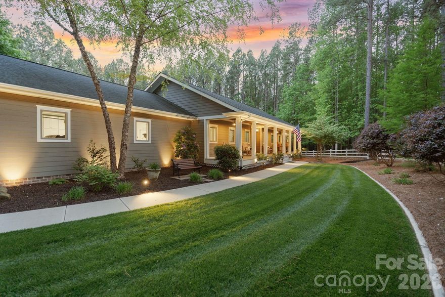 Tucked across from Lake Norman State Park on almost 6 private acres, this one-of-a-kind estate offers a rare combination of craftsmanship, privacy, and intentional design. From the moment you arrive down the 320-foot tree-lined driveway, the property begins to slow life down—offering quiet, space, and a true sense of retreat.

Built by the owner with no detail overlooked, this home was designed to be lived in, not just admired. Every space serves a purpose, and every finish reflects thoughtful planning and long-term quality.
Inside, wide 4-foot hallways, solid core doors, hardwood floors throughout (including closets), heavy crown molding, and detailed millwork set a tone of understated luxury. Anderson high-performance casement windows bring in abundant natural light while framing peaceful views of the surrounding landscape and wildlife.

The main living area feels warm and inviting, anchored by a Mendota fireplace and surrounded by shiplap, brick accents, and custom built-ins. An “English pub” style bar adds character, creating a space designed for gathering, conversation, and everyday comfort.

The kitchen blends function and craftsmanship with black granite countertops, a 36” six-burner dual fuel range, custom cabinetry, recessed counter-depth refrigerator design, and an oversized island with built-in storage.
Just beyond, a gourmet pantry elevates daily living with floor-to-ceiling cabinetry, designer lighting, a beverage fridge, and a dedicated countertop space perfectly suited for a coffee bar setup—keeping the main kitchen clean, organized, and ready for entertaining.

The primary suite offers a peaceful retreat with space for a sitting area or office. The spa-inspired bath features a Kohler cast iron soaking tub and a luxury integrated wet room suite, thoughtfully designed with a separate tiled shower and soaking tub within a seamless spa-style layout, creating a private at-home retreat experience. A fully custom walk-in closet with built-ins and integrated storage completes the suite.

Secondary bedrooms each include private en-suite baths with upgraded tile, granite countertops, custom cabinetry, and designer finishes.

A highly functional laundry/mudroom doubles as a flexible living space, featuring built-in storage, natural light, seating, and hidden Murphy beds for additional guest flexibility.

Outdoor living is equally intentional, with covered front and rear porches featuring tongue-and-groove ceilings, lighting, and fans. Additional outdoor features include a gazebo, fire pit, outdoor shower, and multiple seating areas designed to enjoy the property year-round.

The land itself is a defining feature—almost 6 private acres filled with mature trees, natural beauty, and frequent wildlife sightings.  The proximity to Lake Norman State Park offers immediate access to trails, lake views, and protected green space.

Additional highlights include a fully insulated oversized garage with epoxy floors, built-in cabinetry, workbench, 220 power, and generator wiring. The home is constructed with 2x6 exterior walls, R-23 insulation, and high-quality systems designed for long-term efficiency and durability.

This is not a production home—it is a thoughtfully designed private estate where craftsmanship, comfort, and nature come together.