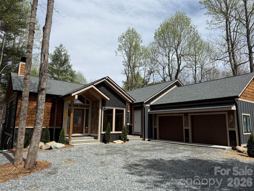Thoughtful design. Luxury and function. Well appointed. Attention to detail. All the words you would expect to hear when describing the unmistakable craftsmanship of another signature Satchmo home. The newest build from Satchmo & Company combines a "mountain rustic" design with modern touches, provides an open concept living space with soaring great room ceiling and offers a main level primary retreat complete with an oversized shower and elegant soaking tub. The home features Rheem 2-zone heat and air, April Air Humidification system, chef's kitchen with 48" gas range and double ovens, gas fireplaces in the great room and den, custom built ins, wine cellar and a wood burning exterior fireplace. Relax on multiple covered porches and decks and enjoy the natural beauty and the peace and quiet surrounding this 1.46 acre home site. Boulder Creek is proximate to both Boone and Blowing Rock, offers the privacy and tranquility of a gated community and features estate size lots set among beautiful rock outcroppings, creeks and waterfalls.