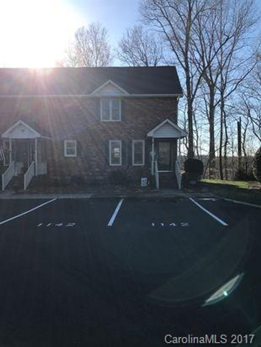 Cozy 2-story condo end-unit with beautiful treed lot and view of pond from rear deck! Updated kitchen is spacious and bright, and opens to dining area. Full brick wood-burning fireplace in the family room. Master bedroom with deep walk-in closet and en-suite recently remodeled with ceramic tile, stand-up shower and vessel sink.  Guest bath and half bath also recently updated. HVAC replaced within the last 3 years and windows replaced within the last 4 years. Roof replaced in 2009.