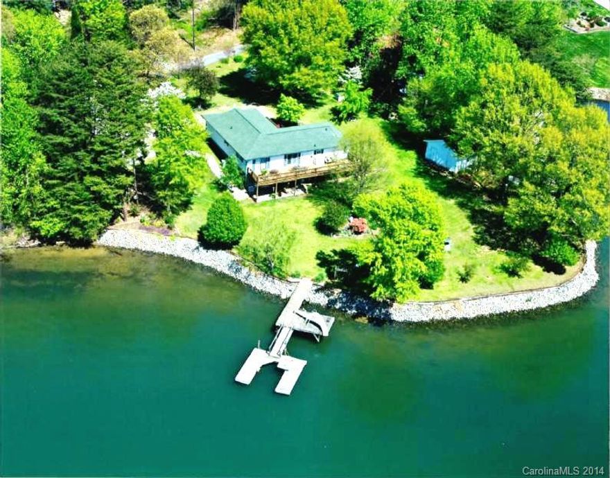 Picturesque Lake Views! With almost 300' of shoreline this gently rolling 1+ acre lot offers over 200 degrees of panoramic views of Lake Norman.  Sit on the rear house full length deck and watch the beautiful sunsets.  One of the nicest lots on Lake Norman!  Features a private dock with deep water access.  Property located on a private road with only 3 other property owners.  Unfinished walk out basement offers limitless possibilities.  New interior paint.