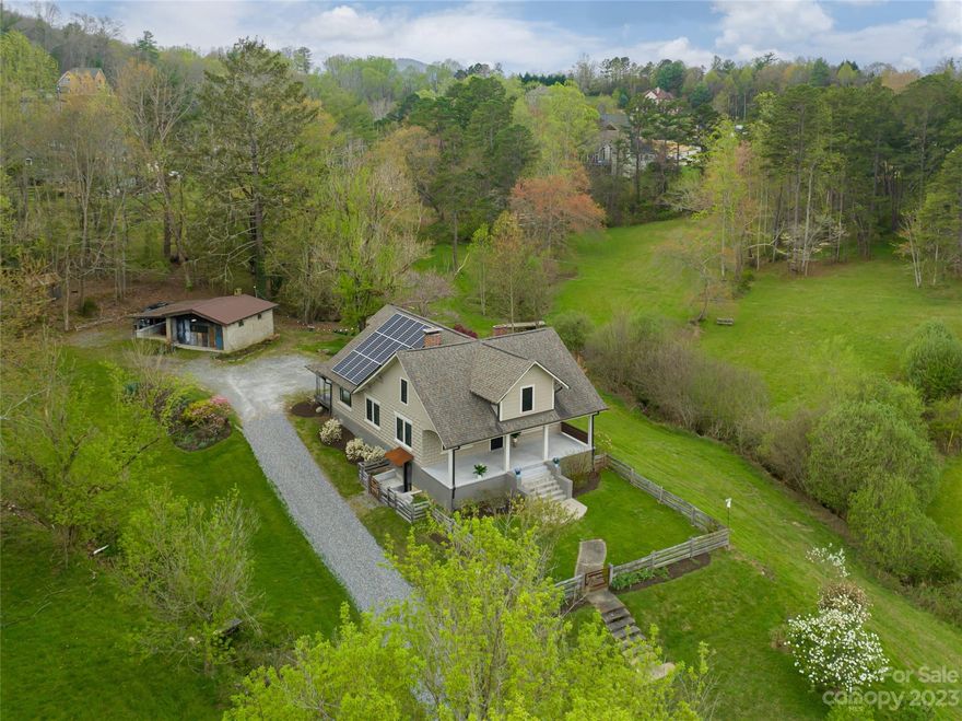 Idyllic mini farm on over 9 acres within minutes of downtown Asheville. Picturesque, remodeled farmhouse with solar panels and detached studio guest cottage with a full bathroom with Airbnb potential. Homestead with pastures for horses, 2+ acres of fenced area with a chicken coop ready for chicks, a shelter for donkeys or goats, 2 streams, and room for addition home sites. Raised beds offer bountiful garden space to plant and grow your own vegetables, plants, herbs, use your imagination! The main Farmhouse is completely updated while still maintaining its character with original hardwood floors and wood burning stove. Entire upper-level primary suite with sitting room/office, walk-in closet, and bonus room. Enjoy coffee on the front porch while watching the sunrise and abundance of wildlife right in your own yard. All the charm of an iconic farmhouse with modern day style and conveniences. Furnishings provided by Atelier Maison & Co and are available for purchase.