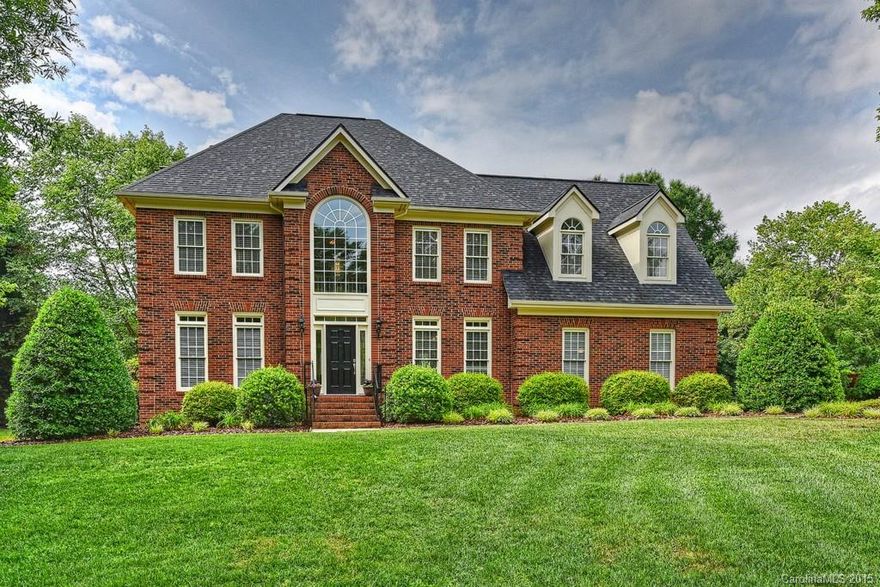 Amazing full brick with park like setting! Features include side load garage with workshop, spacious deck overlooking private back yard, 4 bedrooms, 2.5 baths, (4th bedroom can be a LARGE bonus room) site finished hardwoods on most of main, wood burning fireplace and custom built-ins in great room, kitchen has granite counters, tile back-splash, 42 inch cabinetry and gas range/oven, master bedroom features tray ceiling and recessed lighting. Beautiful lot on nearly an acre! Weddington schools!