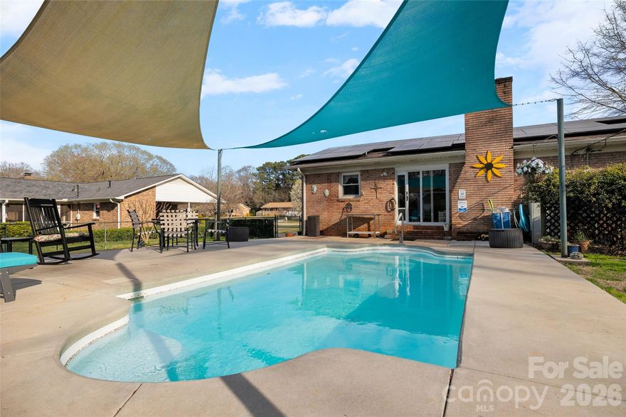 Look at this beautiful pool with sunshade. Come home and relax next to your sparkling salt water in ground pool! The pool area has lots of room for sitting by the pool. Then relax out front on the large porch and enjoy your coffee or a glass of sweet tea. There is a detached 2 car garage with extra storage or workshop area, and more storage on the back of the garage. The home has an extra room off the kitchen, used as an office, or extra entertaining, school area, den or whatever you desire. The back yard is fenced in for security of the pool and for your four-legged babies. The greenhouse does not convey. The home also has solar panels to offset the cost of utilities. This home is not in the city limit, so only county taxes!  HOA is voluntary and is only $25.00 a year. With all this home has to offer, come quick! The home is located in the Cato Estates off Celanese and off Twin Lakes Road.