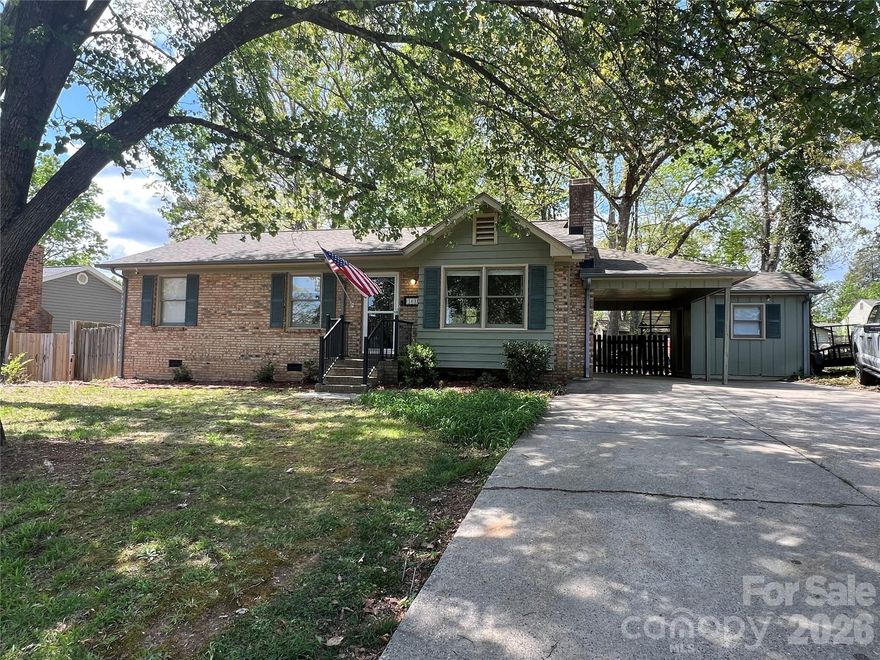 Beautiful home within easy walking distance to Stanley's Harper Park!  MOVE IN READY!  This ranch style home features four year old roof and Trane HVAC. 3 year old electric water heater.  New washer and dryer included with acceptable offer.   Lots of storage! Private back yard with outbuildings, firepit area, and covered patio area.  Attached Shop room off of carport with power and room for storage.  Interior has updated vinyl plank flooring throughout.  The third bedroom has been converted to a spacious dining room perfect for entertaining.  Primary bedroom with en suite bath.  Updated kitchen with granite, new cabinets, electric range, D/W, and refrigerator.  Perfect for first time buyers or downsizers.  All within minutes of charming downtown Stanley!