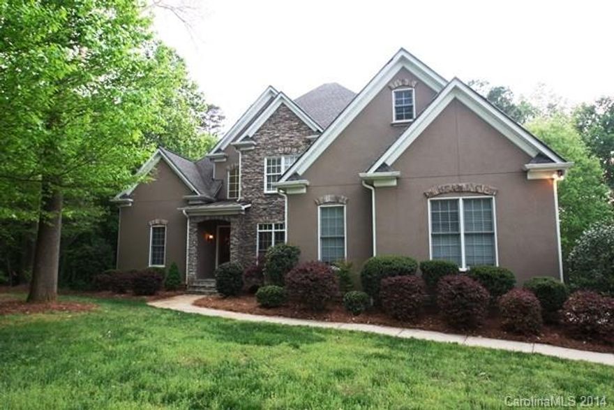 BETTER THAN NEW! Renovated in 2014 this 2-story with full Basement has it all. New flooring including hardwoods and tile, new interior paint, all new gourmet appliances. 2-story GR, 4 fireplaces, Formals, Master Suite on main and 3 Bedrooms w/ Bonus Room upstairs. Finished Bsmt w/ Rec Room, Exercise, Theater, Bedroom, Dining and Baths. Enjoy the Covered Deck and Patio with wooded views. Community has lake access and boatslips may be available.