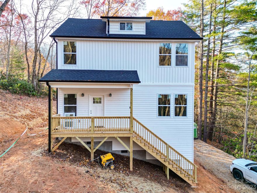 Brand new construction centrally located and convenient to everything Asheville has to offer. Open floor plan bathed with warm natural light is perfect for entertaining. Roomy primary bedroom boasts an extra large walk-in closet and elegant primary bath with dual vanity and refreshing custom tile shower. Luxury vinyl plank flooring, fabulous kitchen with stainless steel appliances, granite counters, spacious all plywood soft close cabinets, under cabinet lighting, and the perfect kitchen island. Neutral colors make decorating a breeze. Large decks are a spectacular place to enjoy that clean mountain air. Well-priced, move-in ready and waiting hold all of your fond memories or become your next charming retreat or sought after investment property. Finished interior pictures are shown as an example. Finishes are usually consistent, but may vary slightly depending on product availability. Tax value based on previous vacant land and does not represent current improvements.