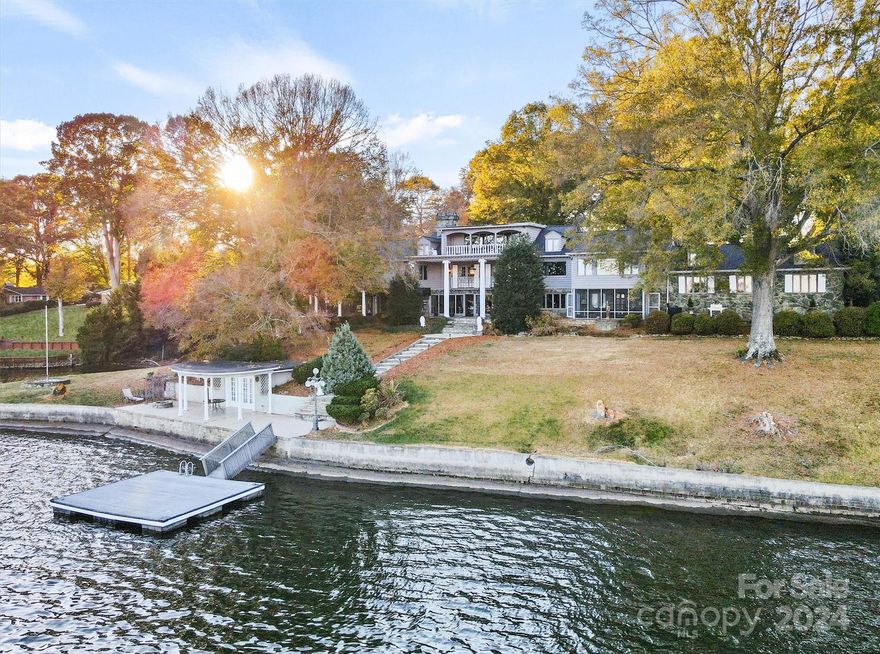 Magnificent estate on sprawling 6.5 lakefront acres and extensive main channel shoreline includes large, main house with 3-bay garage, guest house and ancillary studio apartment w/solarium and gym. Beautiful exposed beams in kitchen and upper level primary suite. Grand entry features elegant double curved staircases. Main level has second primary suites, family/billiards rooms, and 2nd kitchen/bar featuring expansive lake views, veranda, and massive yard. Additional bedrooms, kitchen/dining on upper levels showcase the incredible lake views. Brazilian Cherry and Brazilian Walnut hardwoods and natural stone floors, throughout. 2nd living quarters features desirable layout for guests. Studio apartment above 2nd garage of maintenance building, and also includes a home gym. Lakeside cabana and floating dock make for ease and convenience for long days of boating. Your private Lake Hickory estate awaits.