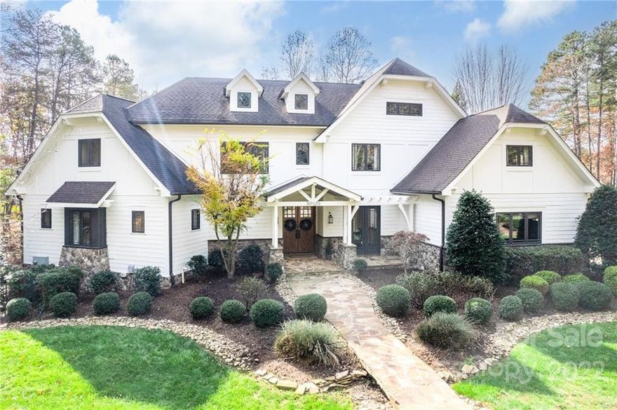 Stunning WATERFRONT custom home REMODELED to perfection! From the moment you enter the door, you will be amazed by the stunning wall of windows towering above the 2 story great room and open this magazine-worthy CUSTOM chef’s kitchen. Three levels of renovated luxury plus exceptional waterfront location in the sought after Point neighborhood. High ceilings on all levels, bright modern improvements & architectural upgrades throughout including an enviable Chef's kitchen with new custom inset cabinetry, massive island, stainless appliances and gorgeous stone range surround! Enjoy water views from your great room with beamed ceilings, custom stone work and massive fireplace. Lovely main level primary suite with spa-like bathroom, three bedroom suites on upper level plus a bonus. Magnificent lake level features family room, 2nd kitchen, wine cellar, media/flex space. BR suite with private entrance, bonus & garage/workshop for lake toys. ROOM FOR A POOL plus country club amenities of TNGC.