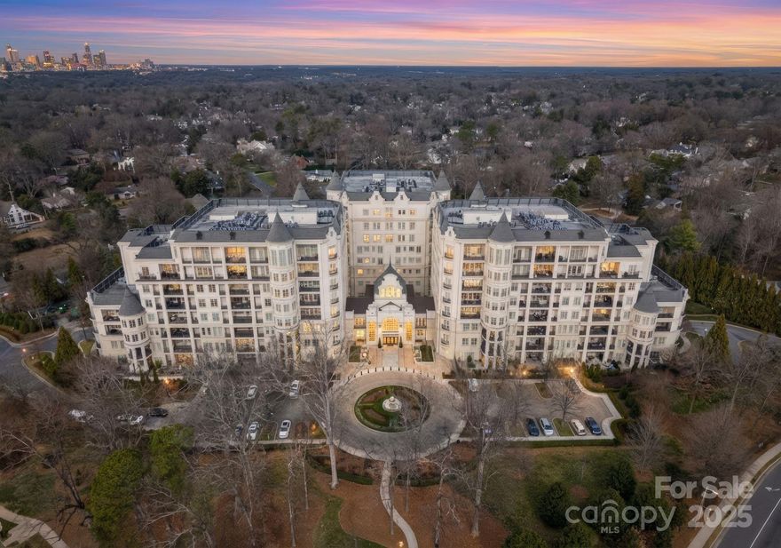 Elevate your lifestyle in this rare 3-bedroom, 3.5-bath penthouse residence in the prestigious Rosewood at Providence. Encompassing over 3,500 square feet, this exceptional home soars above the treetops and offers sweeping long-range views of the city and SouthPark. A gracious foyer and powder room welcome you inside, where timeless design, abundant natural light, and expansive living spaces set the tone. The elegant family room features a cozy gas fireplace and flows seamlessly into an oversized dining room—perfect for entertaining on a grand scale. The gourmet kitchen is ideally positioned for both everyday living and hosting.

A large private office/bonus room with gorgeous built-in bookshelves provides the ideal space for working, relaxing, or library-style retreat. The luxurious primary suite includes a generous walk-in closet and a spa-inspired bath with dual vanities, soaking tub, and separate shower. Each of the two additional bedrooms offers its own en suite bath, providing comfort and privacy for family or guests. A spacious laundry room and separate service entry add thoughtful convenience.

One of the largest and most expansive patios in the building extends your living space outdoors—an extraordinary setting for dining, entertaining, or simply enjoying the panoramic views. The unit also comes with 2 deeded and secure parking spaces (one with an EV charging unit) along with a separate storage room.

Residents of The Rosewood at Providence enjoy resort-style amenities including 24-hour security, concierge services, gated parking, business center, fitness center, outdoor pool, and tennis and pickleball courts, along with elegant gathering areas featuring a gourmet coffee bar, fireplace, and card room. This is refined condominium living at its very best.