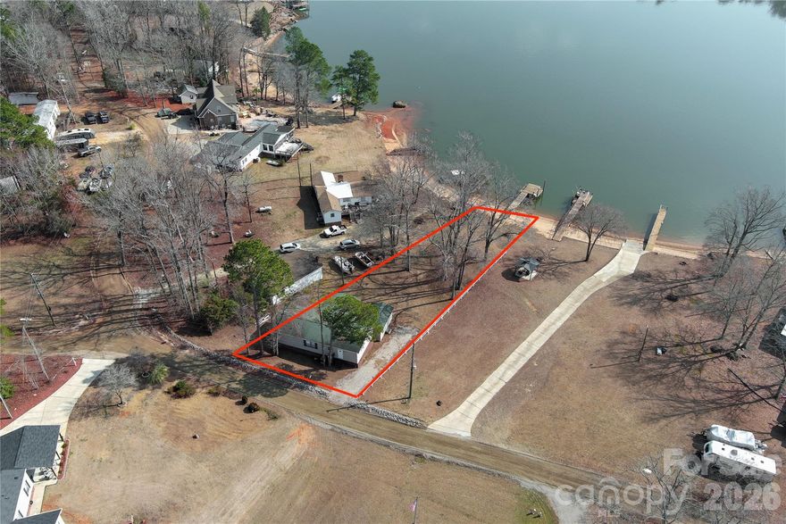 Welcome to your own private lakeside retreat! This stunning lakefront property offers unparalleled beauty and tranquility with sweeping water views! Whether you’re a boating enthusiast, fisherman, or simply someone who enjoys peaceful lakeside views, this home provides the ultimate in lakefront living. With your own private dock, you can easily enjoy water activities and unwind by the lake. The large screened porch deck is perfect for hanging out with friends and boat watching.  Outbuilding with ramp is great for golf cart storage and Lake toys.  Home boasts 3 bedrooms and 2 full baths. The Riverdeck convenience store/grill, ABC store, gas for boat and car are within walking distance from the house. There are 2 other restaurants close by with 1 that offers a variety of entertainment most of the year and the other restaurant is right across the bridge. It is located on Beaver Creek a very popular Destination to hang out with the locals and have fun in less than I have a mile away?