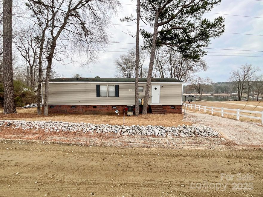 Welcome to your own private lakeside retreat! This stunning lakefront property offers unparalleled beauty and tranquility with sweeping water views! Whether you’re a boating enthusiast, fisherman, or simply someone who enjoys peaceful lakeside views, this home provides the ultimate in lakefront living. With your own private dock, you can easily enjoy water activities and unwind by the lake. The large screened porch deck is perfect for hanging out with friends and boat watching.  Outbuilding with ramp is great for golf cart storage and Lake toys.  Home boasts 3 bedrooms and 2 full baths. The Riverdeck convenience store/grill, ABC store, gas for boat and car are within walking distance from the house. There are 2 other restaurants close by with 1 that offers a variety of entertainment most of the year and the other restaurant is right across the bridge. It is located on Beaver Creek a very popular Destination to hang out with the locals and have fun in less than I have a mile away?