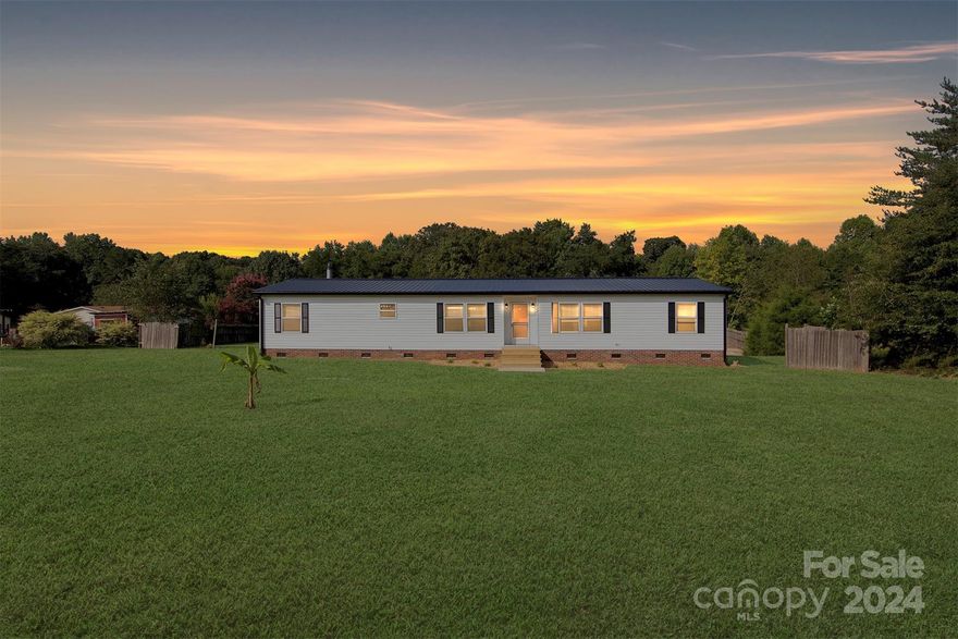 Beautifully renovated, move-in ready home! Located in a quiet country setting, on a cul-de-sac and with .99 acre of land, close to shopping with an easy commute to Charlotte, Hickory or Lincolnton, it's perfectly located. At over 1800 sq feet with 3 beds, 2 full baths and flex space, there's plenty of room.  Enjoy your beautiful back yard from your two back decks and use the large concrete pad for whatever your heart desires! Pickle ball court, Parking pad... So many options. Don't miss this truly like new home!

Updates include a new metal roof, new gutters, vinyl windows, water heater, air handler, waterproof vinyl plank floor, vinyl siding, stainless steel kitchen appliances, countertops and cabinets, bathtubs, toilets, showers and vanities, light fixtures, wooden covered deck and new insulation in the majority of the crawl space. Also, the septic has been inspected and pumped. Closing Costs Offered!