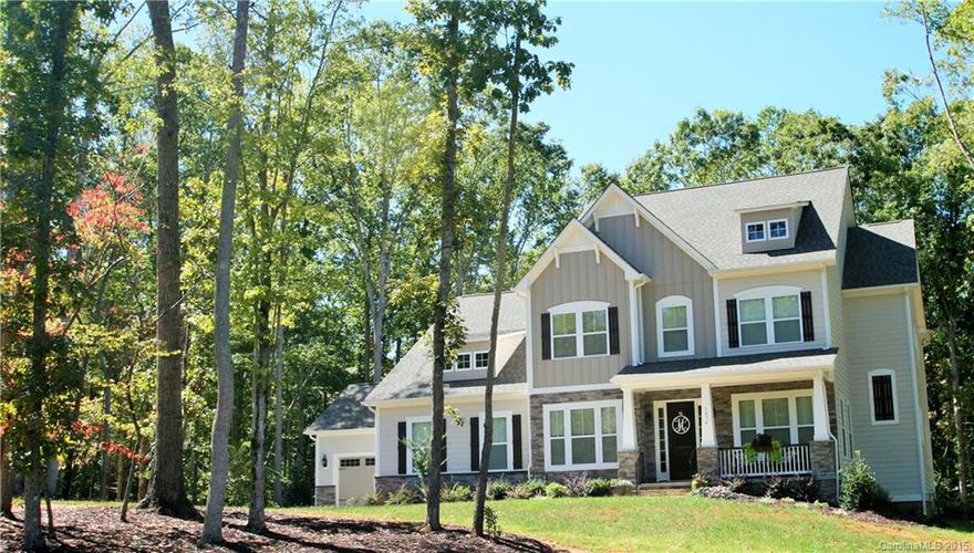 This stunning 3 story home has the largest private, wooded lot & a 4 car garage!  The 5bd/5.5bth plan includes an office, butler pantry, bonus rm, Rec rm, mud rm, walk in pantry, another suite on 3rd floor & expect to be impressed w/all the upgrades incl granite, coffered ceiling, 5inch crown molding & much more. The beautiful 5 inch hrdwds are throughout the main level & landing. Gourmet kit w/a large island opens up to the 2 story great room which is great for entertaining guests. Must see!