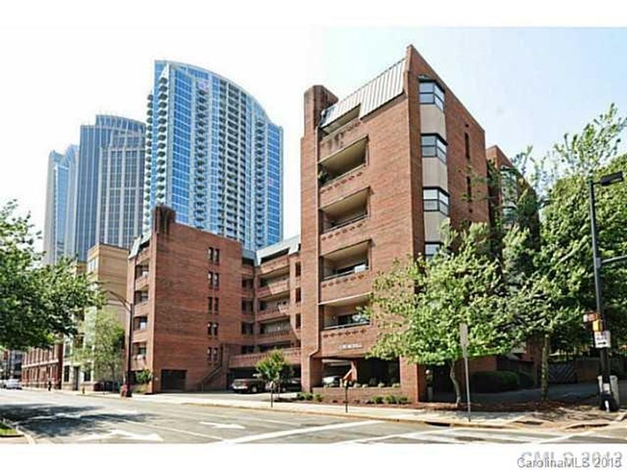 Beautiful 800+ heated sf condo with new appliances, fireplace, balcony with views of Fourth Ward Park & Charlotte skyline. Spacious bedroom with two closets! Full bath with ceramic tile, dedicated parking space, secure lobby. Washer & Dryer unit in condo and conveys. Churchill was the first condominium building in Charlotte built in '82,  is steps from Harris Teeter walking distance of Discovery place, parks, performing arts center, and the best dining and entertainment the city has to offer.