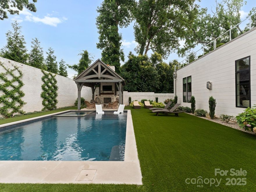 Kenwood Sharon Lane is an exclusive enclave of 10 custom homes developed by Jim Gross, designed by Don Duffy and constructed by Thomasson Builders. Walls of windows, open inviting floor plan, bright and airy.  This incredible home has a primary on the main with an expansive custom closet and gorgeous spa bath. The upper level offers 4 bedrooms w/ en-suite baths & generous closets, a large family room overlooking the private roof top terrace that is 25' by 29'. Incredible brick enclosed private backyard oasis with a pool, spa, covered veranda w/ a fireplace and built in grilling station, The kitchen has Sub-Zero and Wolf appliances, custom cabinetry, large pantry and a separate scullery. There is a beautiful dining room, office that could also be used as a living room, large family room open to the kitchen and breakfast room, and a large laundry/mud area. Unique opportunity to own a residence in the sought after Foxcroft location, minutes to uptown, Myers Park and Southpark.