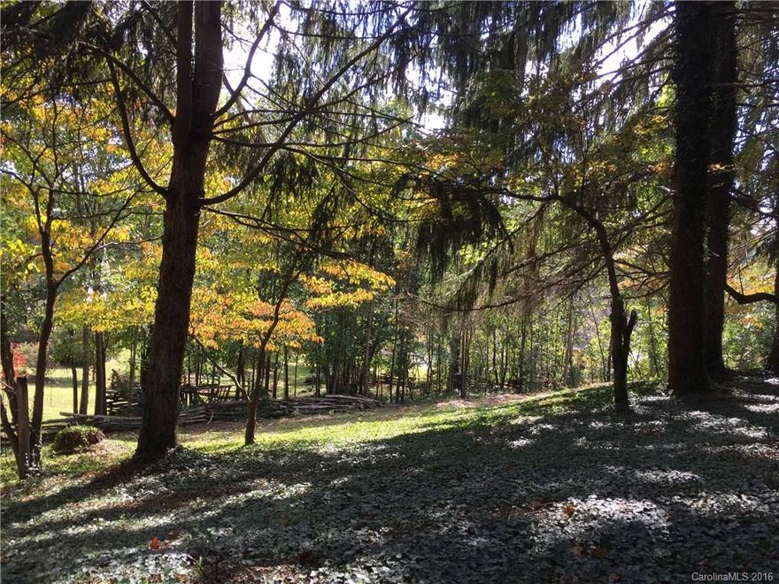 Incredible value on rare building lot in desirable north Asheville location! Close to Beaver Lake, Asheville Country Club, area of many fine homes ($400K+). Gentle laying lot appears to offer long range views to south. Shared driveway with 6 Mayfield saves on driveway costs plus offers wrought iron security gate (remote control) with Granite pillars! Public water at street, sewer nearby or install private septic. Custom plans on file from quality local builder.