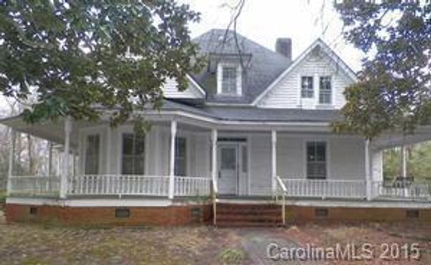 Attractive 1920's built two story home with wrap around porch, located in a well established rural community.  Enjoy the shade of the huge front yard trees or roam around the spacious back yard. This home features hardwood floors, den with built in bookshelves and fireplace, living room with fireplace, foyer with staircase leading to second floor, country kitchen, two main floor bedrooms and two main floor bathrooms.  The second floor landing leads to four spacious bedrooms and one bathroom.