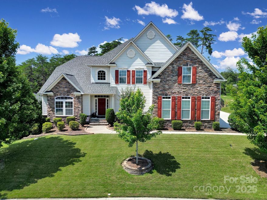 Stunning ¾-acre oasis in highly sought-after Tega Cay! This 2-story brick & hardboard siding home features a French door office, 2-story great room with coffered ceiling with a gas fireplace, and hardwood floors on the main and  tread stairs. The spacious main-level primary suite includes a tray ceiling, garden tub, shower, and custom his & her closets. The updated kitchen boasts quartz countertops, tile backsplash, new appliances (excluding double ovens), and a custom walk-in pantry. Upstairs offers 3 bedrooms—two with Jack & Jill bath, one with private ensuite—and a large bonus room. The laundry room includes storage cabinets and a sorting counter. Epoxy garage floors and overhead storage complete the home’s thoughtful features. Recent updates: interior paint, carpets, kitchen upgrades, rebuilt and extended deck, backyard custom firepit with seating, extensive exterior lighting, and a new HVAC in 2022. A perfect blend of luxury, comfort, and function, More info in Agent Remarks.