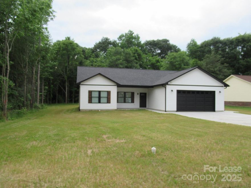 This charming, new home boasts over 1,500 square feet of well-designed living space. Located just minutes from downtown Lincolnton, it offers both convenience and modern comfort. The spacious kitchen features elegant granite countertops and brand-new appliances, perfect for preparing meals. The large den with vaulted ceilings and a ceiling fan creates an open and airy atmosphere.  The primary suite is a true retreat, complete with a dual vanity and a walk-in closet. The two additional bedrooms are generously sized, offering plenty of space for family or guests. Outside, enjoy a covered front porch and a rear covered patio, ideal for outdoor gatherings and relaxation.  A roomy, oversized concrete driveway leads to a two-car garage, providing ample parking and storage.  Note: An application is required for lease consideration.