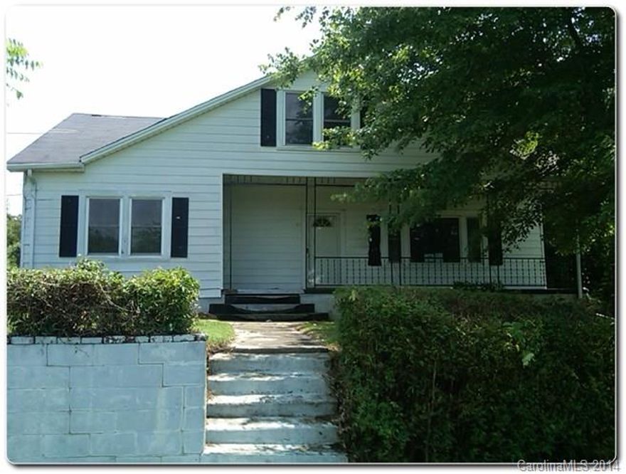 Fascinating 1.5 Story home w/ detached 2 car carport, large front porch & covered patio located in South Gastonia. Original floor-plan, good size kitchen w/ breakfast area connecting to a separated dining area and a den on the other side. Master & a main bath on the 1st level plus an office. Upstairs 3 rooms, all have some closet space. Outside 2 older outbuildings and backwoods full of large bushes and mature large trees.