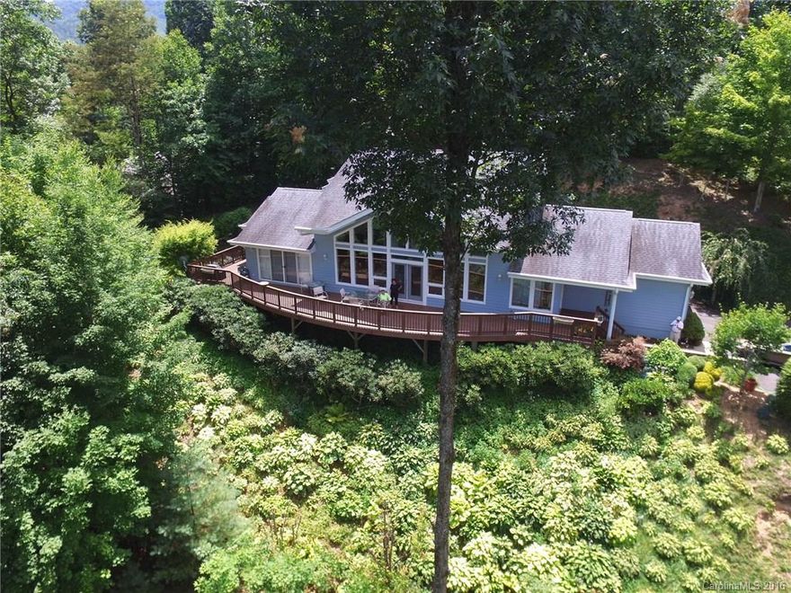 Contemporary mountain home on private 1.77 acre lot w/stunning year around views! You will be mesmerized by the constantly changing views from sunrise to sunset! Home features open floor plan w/ vaulted ceilings & a wall of glass in the great room. Wake up to direct mountain views from the master bedroom & walk out onto the large deck. Additional features include breakfast bar, wood & tile floors, office space on main, large walk in closet, & loft area on 2nd level.  Minutes to the Maggie Club!