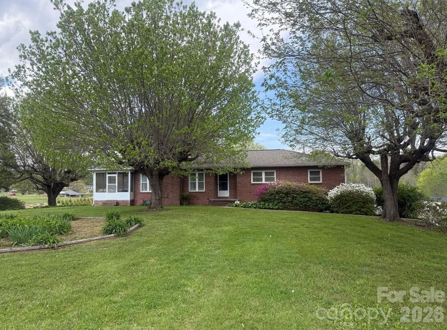 Welcome to this charming 3 bedroom, 2 bath brick home located in the countryside of Etowah.  This home offers the perfect balance of privacy and convenience.  The property offers ample outdoor space for a garden, pets, outdoor entertaining, while enjoying living in the country. Despite its serene setting, the home is conveniently located just minutes from Highway 64, providing easy access to Brevard, Hendersonville, Asheville and nearby shopping and dining.  The home has a full basement with lots of storage, workshop, hobby space or future expansion to create additional living space. If you're searching for a brick home in Etowah with a basement and room to grow, this property is full of potential and ready for its next owner.  Give us a call today for a showing.