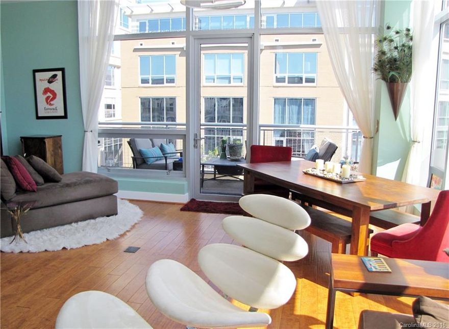 Corner top-floor condo w/elegant furnishings, floor-to-ceiling windows w/motorized shades, 10' ceilings, breathtaking views, hardwoods and tile, high-end cabinets and faucets. Kitchen w/SS Viking appliances (gas range and convection oven), Sharp microwave, granite counters, mosaic tile backsplash. Walk-in closet w/built-in organizer. Bath w/heated floors and large shower. Roomy balcony w/grill. 1 reserved parking space in deck. Building has clubhouse, gym, rooftop pool and lounge w/grill area.