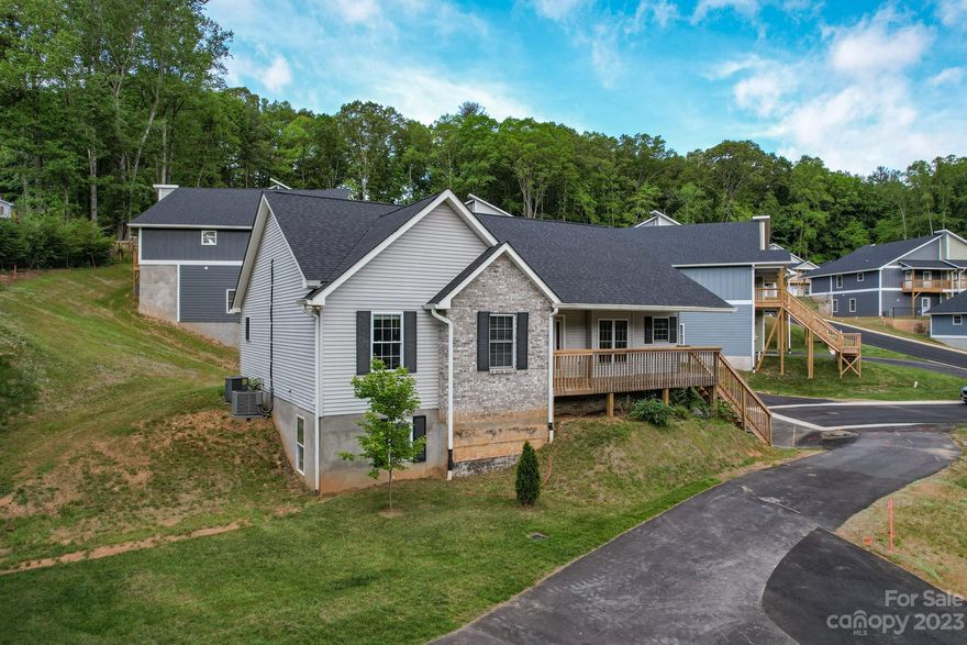 BEST DEAL AROUND! Incredibly spacious 1,768 sf 3br/2bth with fureplace 2nd floor condo with convenience to Asheville, but outside of city limits. Large open living room with vaulted ceilings and gas fireplace. Large dining room and breakfast nook. Next to kitchen is a walk- in pantry/ utility room for washer dryer. Large back deck offering ground level entrance to kitchen. Front porch with mountain views. UPDATED- with new hardwood flooring in living room, dining room, and hallway, new carpet in bedrooms, tile in bathrooms, all new plumbing and light fixtures, bathrooms with granite counters, new stainless steel appliances in kitchen, HVAC System, and hot water heater.  Large Primary Bedroom has shower with separate tub and walk in closet. Also has new roof: This unit allows STR if you want!!!!