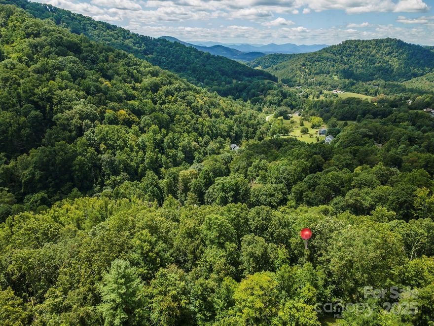 Private wooded lot tucked back at the end of a cul-de-sac. The terrain is gently sloping and very buildable with a driveway access already started into the property. Expired septic permit in place for a 3 bedroom home. If you're quiet enough, you'll catch a glimpse of the deer who like to hang around. Access to property is paved and maintained by the HOA. Seven Glens is a stunning community that is well established in Western North Carolina. 25 min to downtown Asheville, 15 min to Weaverville, and 10 min to Mars Hill. Located in Madison County just across the Buncombe County line. Enjoy hiking, biking, golf, rock climbing, fishing, rafting, and skiing nearby. Or find a local coffee shop, brewery, or park for a more relaxed mountain experience. Great opportunity to build your mountain getaway.
