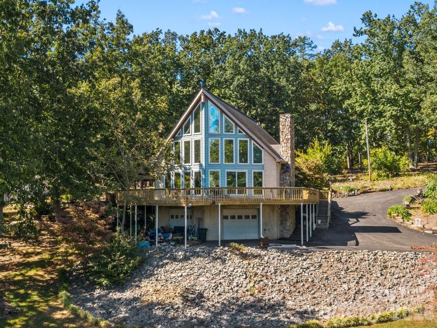 Absolutely stunning and one-of-a-kind property! This custom A frame home sits at the end of a cul-de-sac on 9 acres of land. NO HOA! The view from the wrap around deck and the main living area is unmatched. It feels like you are in the High Country but in Gaston County. Views of Spencer Mountain, Crowders Mountain, and the CLT skyline on a clear day. You will have a front row seat on 4th of July seeing multiple firework shows from your front porch. This home offers an in-ground pool, sheds, a greenhouse, pond, fruit trees, privacy and much more. The inside will have you in awe with the custom windows overlooking the view and the large wood burning fireplace. Basement is completely finished offering additional bedrooms and a full bathroom. 2 Secondary bedrooms on the main with 2 full baths. Upstairs offers a private ossias to the Primary Suite that also offers the view of the property. Primary suite has tall, vaulted ceilings, multiple closets. Large Primary bathroom with double vanity sinks, option for a jetted tub, and private tub/shower. Also has it's on hot water heater AND HVAC! Large carport supports 4 vehicles and the attach garage was built for your recreational vehicles/ workshop. Private winding driveway is beautiful and looks beautiful in every setting. This is a rarity!