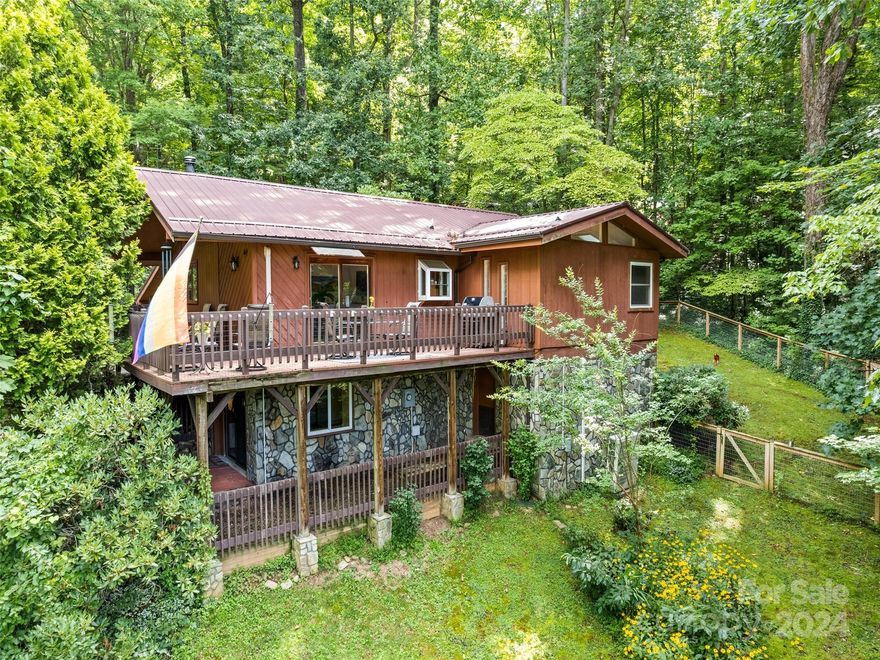 Discover this delightful 2-bedroom home, featuring 2 fully upgraded bathrooms and an additional half bathroom, ideal for primary residence or short-term rentals. Boasting a basement with its own entrance, the property offers versatile living spaces and convenience. Enjoy picturesque mountain views from the wrap-around, partially covered porch or relax in the fenced-in side yard. Located just 1 mile from downtown Waynesville in a quiet neighborhood, this home includes a durable metal roof installed 5 years ago, built-in shelving in the closets, and a cozy wood-burning stove. Perfect for both serene living and rental potential, this property seamlessly combines comfort and charm.