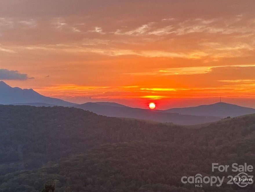 BRING ALL OFFERS !! Wow! What a remarkable view! Amazing long range views of Grandfather Mountain and many more mountain ranges. Elevation of over 4400 FT. Inside you will appreciate the big open view through the massive windows from the Living Room, Enjoy the kitchen with granite counters. Vaulted ceilings, stone fireplace, and wood floors make this a mountain paradise. The beautiful wrap around deck lets you enjoy the outdoors as well while you take in the breathtaking views and morning sunrises. Main level offers Primary Bedroom and Bathroom with Jacuzzi Tub. Primary also has a 6x12 walk in closet. The laundry room is on main level as well. The lower level offers 2 more Bedrooms and a Bath. There is a play room/Den on that level too. Attached 2 car garage, oversized detached 24 x 48 work shop/RV storage and detached carport offer more than enough covered or enclosed parking. Outside of home has new stain on Exterior Logs and fenced back yard. $1500 appliance allowance to new buyer.