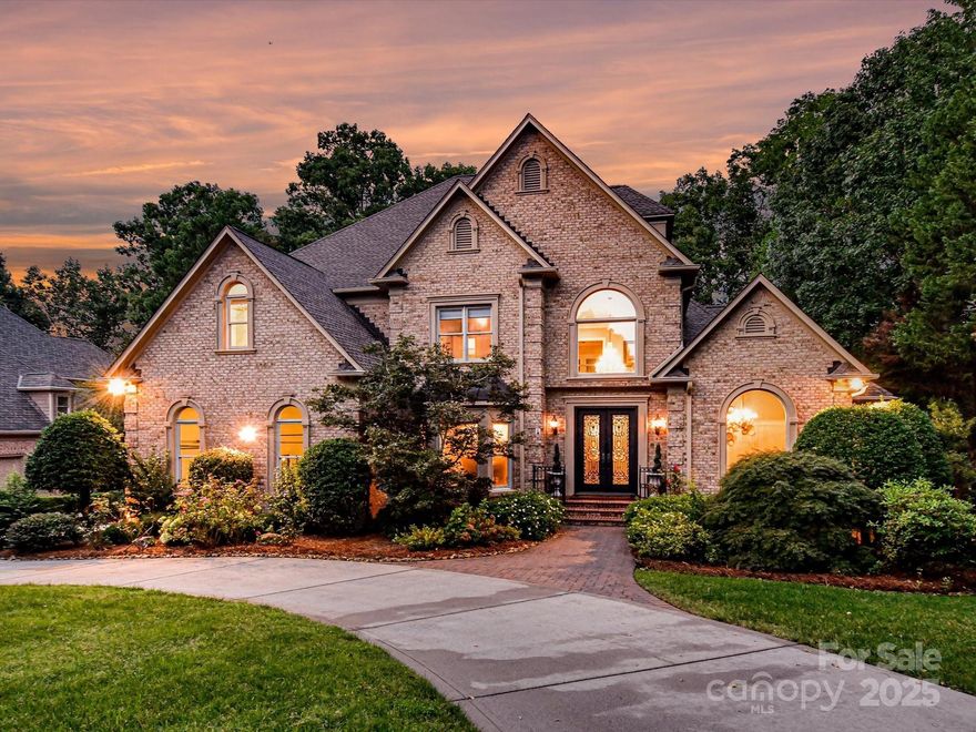 Discover the epitome of luxury living in this stunning executive home, perfectly situated overlooking the 18th fairway of Ballantyne Country Club. Generously sized to offer versatile living arrangements - this residence offers abundant space for everyone. The gourmet kitchen is a chef's dream, featuring an island w/seating, desk area & large dining space complete w/cozy fireplace. Step outside to your private terrace w/newer stone flooring, piped gas line for grilling & easy access to the outdoor pool & fireplace. The main level boasts a lavish primary suite w/a spa-like bath & multiple closets, while the upper level offers additional bedrooms w/ensuite baths, family room leading to a balcony & office. The basement is a true showstopper, featuring a theater, wine cellar, bdrm, full bath w/steam shower & luxurious sauna. Two spacious 2-car garages & an outdoor oasis complete w/a saltwater pool, fireplace & golf course views, this home is the ultimate retreat! BCC membership optional.