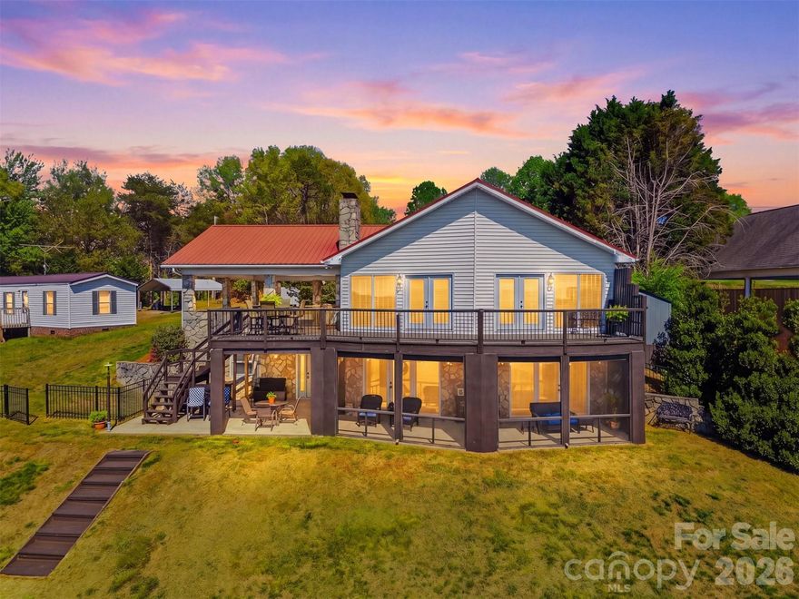 Experience lakefront living at its best with this fantastic new listing on the main channel of Lake Hickory. Enjoy sweeping long-range views, deep-water access, and a recently replaced dock roof — all with no city taxes and no HOA fees. It’s the perfect blend of privacy, convenience, and year-round lake enjoyment.

The main level is designed for effortless relaxation and entertaining. An oversized carport welcomes you inside to a bright kitchen and den, both showcasing stunning lake views. This level also includes two generous bedrooms, a full bath, and a spacious deck ideal for morning coffee or sunset gatherings.

The lower level offers flexible living options, featuring a music room or office, a primary en suite with a convenient laundry closet and access to a screened porch, plus a large den that works beautifully as an entertainment space or billiards room. A dedicated workshop completes the level, giving hobbyists and DIYers plenty of room to create.

Adding even more charm and versatility is the one-of-a-kind boathouse cottage. This unique space includes a full bath, kitchenette, and private deck — perfect for guests, a studio, or a peaceful lakeside retreat. The lower portion serves as a boat garage with a concrete ramp, and the dock sits just steps away for quick, easy access to the water.

This is a rare opportunity to own a true main-channel gem on Lake Hickory — a place where every day feels like a getaway.