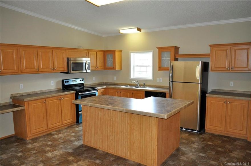 Exquisitely remodeled home on large lot in super convenient location. Must see kitchen with large island/bar and all new stainless steel appliances. Fireplace in den has never been used.  New wood laminate floors and wall to wall carpet throughout.  Fresh paint and this home feels like new! 3 large bedrooms and 2 full baths.