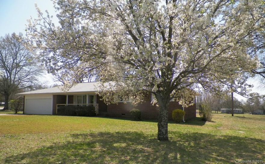 REDUCED!!!! Don't miss this spacious ranch located on over 1.5 acres.  It features a large kitchen/dining/den, formal living room with hard wood floors, three bedrooms, two baths, attached garage and covered concrete pad area with view of the adjacent pond.  The established yard trees offer an attractive array in the Spring season. Make this house a home with your own renovation/update ideas.