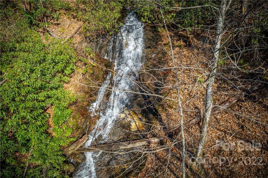 This an incredible opportunity to own a dynamic mountain waterfall property just minutes from the Maggie Valley Club! With over 7 acres (5 parcels) there are several homesite options with a few close to the waterfall/stream perfect for a private estate. There is public water and sewer available and paved roads. The waterfall is over 100 feet long of rushing, fresh mountain water. Within the largest parcel is an out-of-use sewer facility that could be converted to a garage, workshop, etc. There are multiple points of access to the different lots. The Maggie Valley Club offers golf membership, sports memberships (pool, tennis, fitness), and an onsite restaurant. The property is located less than 15 minutes from Waynesville, 35 minutes to Asheville, and 30 minutes to Cherokee.