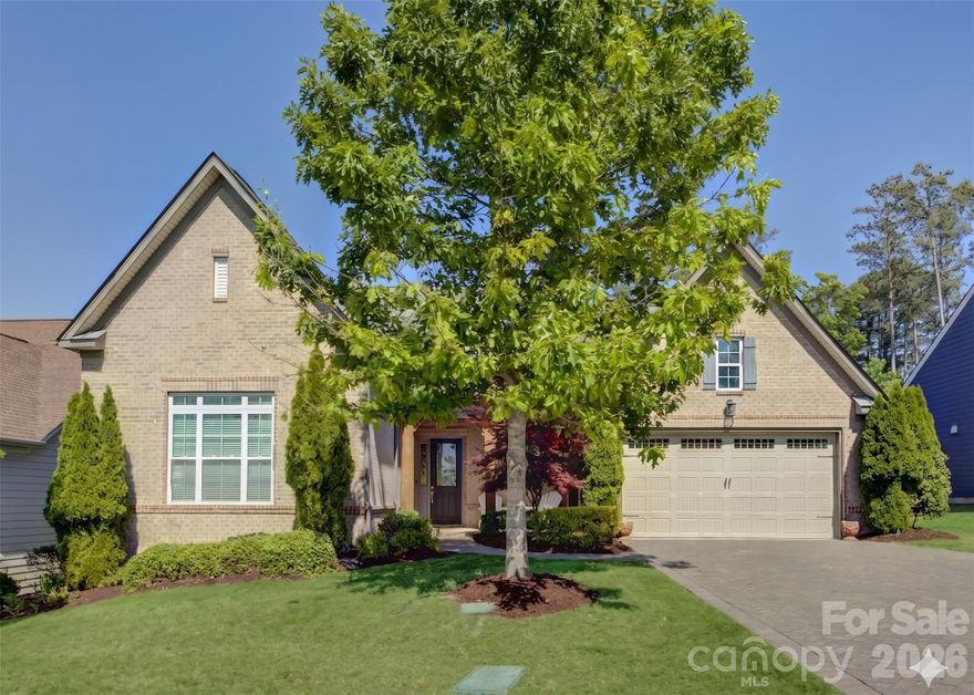 Experience luxury living in this charming 1.5-story former model home nestled in the amenity-rich Palisades community. A grand two-story foyer welcomes you inside, where a private study with French doors sits just off the entry. The gourmet kitchen impresses with ample white cabinetry, granite countertops, a prep island with pendant lighting and bar seating, a single-bay sink, a gas cooktop, an exhaust hood, and a wall oven, all flowing seamlessly toward sliding glass doors that open to a screened porch with a stunning stacked stone fireplace—perfect for year-round enjoyment. While enjoying the paver patio, take in serene views of the award-winning Jack Nicklaus–designed Palisades Golf Course. The light-filled living room features a dramatic wall of windows and a stacked-stone fireplace flanked by built-in shelving. The main-level primary suite offers a deep tray ceiling, dual vanities, a double-head glass-enclosed shower, and spacious closets. Bedrooms two and three share a hall bath. Upstairs, a versatile loft provides the ideal media space, along with a private guest suite featuring a full bath. Residents of the Palisades enjoy exceptional amenities, including a clubhouse, resort-style pool, fitness center, tennis courts, playgrounds, miles of walking trails, and access to Lake Wylie, with optional golf and social memberships available at the Palisades Country Club. This home perfectly blends elegance, comfort, and an active lifestyle in one of Charlotte’s most sought-after communities.
