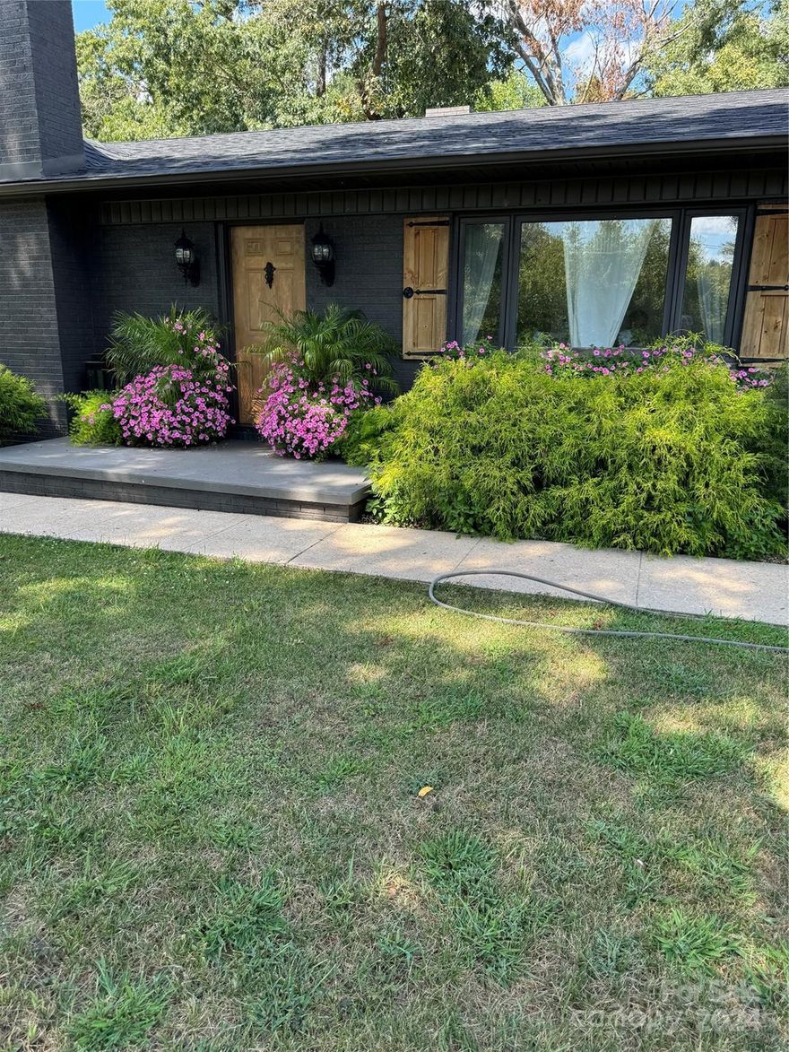 2.2 +/_ acres, located in a charming neighborhood, offering privacy and great neighbors. rear patio where you can enjoy the quite peaceful relaxation while enjoying the outdoors. Just a couple of minutes from Mcgalliard Falls Park in Valdese. House has just been recently updated and gorgeous decor. Flooring update to a modern touch, great kitchen with island, cooktop and oven, perfect for culinary adventures. Beautiful living room with a fireplace for those cozy evenings. New roof, 2/car, carport, with a garage in basement being used as an exercise room. 3/beds upstairs and one downstairs, bath upstairs and one downstairs. Basement is finished except for the garage, could be used for a live in parent or family member, full kitchen with laundry and dryer hookup, with entrance door. Heated and cooled with heat pump upstairs and split unit downstairs. Detached workshop 30 X 22 two stories. Every man's dream for a place of solitude to woodwork or do other projects that he enjoys.