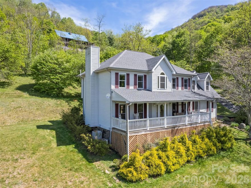 Long-range mountain views, the soothing sound of a rushing stream along the property line, and an unbeatable location just 700 feet from the Blue Ridge Parkway—or only 2 miles to a Parkway entrance—make this mountain home a rare retreat. Relax on the full-length front porch while enjoying the views and listening to the stream below. Inside, oak hardwood floors and solid construction create a warm, welcoming feel. The main level features a spacious living room with a gas log fireplace, formal dining room, half bath, and an eat-in kitchen with granite countertops, stainless appliances, and access to the open back deck—perfect for grilling and entertaining. Upstairs, the primary suite offers its own gas log fireplace, large closet, and ensuite bath with a soaking tub and walk-in shower. Two additional bedrooms, another full bath, laundry area, and an oversized 20x11 flex space or bonus room provide plenty of room for guests, hobbies, or a home office. Two parcels are included: the home sits on one parcel, while the second parcel features a large detached garage/workshop ideal for storage, projects, or recreational gear. Easy-maintenance vinyl siding, being sold FURNISHED, a 2021 roof, no HOA, no city taxes, and convenient access just 5 miles to grocery shopping and 7 miles to Main Street Waynesville complete this exceptional mountain property.