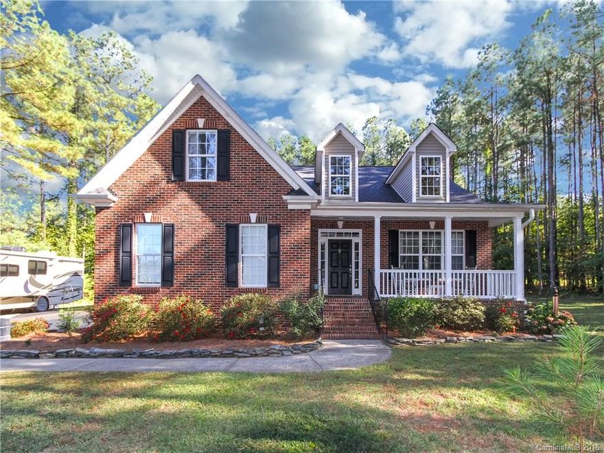 Beautiful, 2 story home on RARE, private 1.2 acre lot. Enjoy the peaceful setting on the rocking chair front porch or large rear deck and fenced yard.  This home has it all -hardwoods on main, two story foyer, formal dining and living rooms, coffered ceilings, built in bookcases, master on main, second master up, and extra parking for your boat or RV. Second floor bonus could be used as a fourth bedroom.