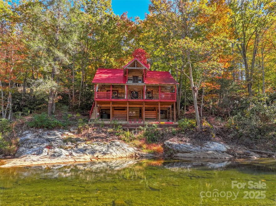 Rare, historic, hand hewn and chinking (1800's per seller) log cabin nestled on the South Toe River, that flows from Mt. Mitchell, highest mountain peak, east of the Mississippi River. This romantic log cabin was originally living off of Hwy 80 S, where the Laurel Heights community is. The history is, that it was a resting place for weary travelers to lodge overnight(per sellers and the info they have gathered, no documentation). It was moved(disassembled) in 1984, and reassembled, where its home is now, with over 1,000 feet of riverfront. The present owners has made many improvements assuring stability, with engineered, 200 cubic yards of concrete, metal roof, rustic beams, esthetic decorative wrought iron railings, with about 800 sq. ft of covered outdoor living/entertaining. It encompasses spacious 2 bedrooms, one with a wood stove, both have vaulted ceilings with beams, and wood floors. One and a half bath with claw ft. tub/shower, open style kitchen/dining with country brick floors. Generous living room with wood burning stove, and foyer, all viewing the river from both levels. Storage room with laundry on main level, outside of entrance door. Underneath is a large bonus area for outdoor entertaining, and river access for fishing, tubing, kayaking, or just absorbing nature in the serene riverside valley. The road is a quiet country road less traveled. This unique log cabin is a eccentric find for your paradise summer getaway or short term rental! Minimal damage from the storm and is now restored. The kitchen cabinets is a blank canvas, for your artistic touch. Possible studio apartment where shed is. Comes with furnishings and decor!