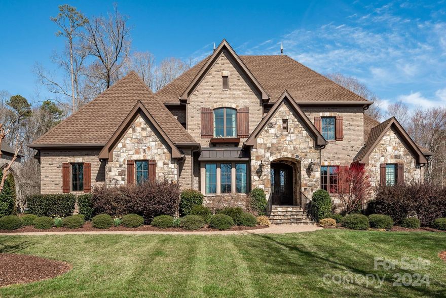 Located in one of Union County's most prestigious gated communities, top rated school district. This property has been thoughtfully curated offering a blend of elegance/comfort. Spacious open flr plan w/lofty ceilings, site finished walnut floors. Study is a haven for productivity while the DR w/butlery, conditioned walk-in wine storage is built for entertaining. GR has a stunning stone frpl, coffered ceiling, custom built-ins. Kitchen is a chef's delight w/prof-style appls, custom hood, island. The adjacent keeping rm offers cozy stone frpl, beamed ceiling. Gracious primary suite, luxury ensuite bath, custom designed closet. Laundry rm has ample cabs, cntrs, plus sink. 4 gracious sized BR's up, each connect to a BA ensuring privacy. Flex spaces include exercise rm plus bonus/media rm offering endless possibilities. Step outside to the covered porch and stone patio where you can enjoy the serene view. Community amenities: pool, tennis courts, walking trails, offer an active lifestyle.