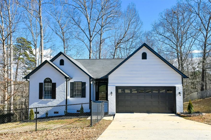 MULTIPLE OFFERS! Deadline Sunday 1/28 at 4pm. Beautiful and tastefully renovated ranch home in a cul-de-sac in very desirable Hawk Ridge neighborhood with NO HOA!. This 3-bed/2-bath home with 2-car garage with fenced in yard has been completely painted outside and inside, with new modern landscapining, all new LVP flooring throughout the house, both bathrooms have beautiful new modern tile, new vanities, fixtures, mirrors and lighting! All new recessed lighting installed to allow you to enjoy the modern open space with vaulted ceilings and brand new blinds on all windows throughout the house. Step outside to your freshly painted deck and enjoy the very private wooded view. Perfect to enjoy many evenings with friends & family. Home has brand new water heater (2024) & HVAC (2021).Convenient to shopping, grocery, dining & just minutes from Martha Rivers Recreation area!