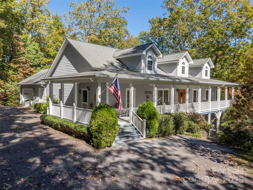 A Southern Lady with a Saluda Charm!  Charming Southern-style home with wraparound porches on both levels, perfect for relaxing or entertaining. Step into a soaring foyer leading to a cozy sitting room, formal dining, powder room, and a well-appointed kitchen that opens to a great room with trey ceiling, fireplace, and rich oak floors. The main level features split bedrooms, baths, an office, and spacious laundry. The lower level offers a full in-law suite with 2 bedrooms, bath, kitchen, family room, eat-in area, private porch, and 1,050 sq ft of storage. Enjoy a 118 sq ft workshop off the driveway. Nestled on a beautifully landscaped, wooded lot with trails and large rock features, this private retreat is perfect for making lasting memories!