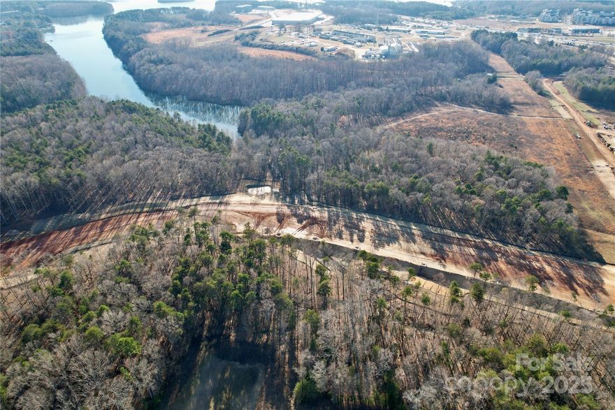Prime Development Opportunity on 7.92 acres off of Langtree Road, Mooresville, NC. This property is zoned Corridor Mixed-Use (CM), offering immense flexibility for a range of uses, including multifamily housing, retail, and office developments. Situated directly across from Lowe’s Home Improvement’s corporate headquarters, a sprawling 275-acre campus developed to house up to 10,000 employees, providing a built-in market for future development. Adjacent to the upcoming East-West Connector Road, currently under development, which will further enhance accessibility and traffic flow in the area. Completion date Q3 2026 Easily accessible to I-77 at Exit 31