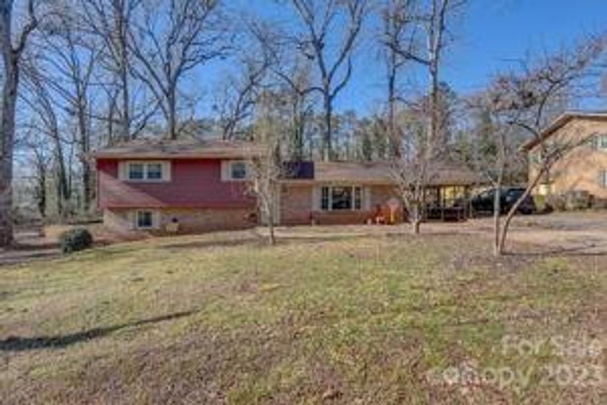 This home has many options for a BIG family. Home sits on almost an acre with a creek. So when viewing this property don't forget to take the beautiful deck path down to the creek. Potential to be a 5 bedroom home.  Fenced Backyard. Laundry room, half bath and Fireplace located in Fully Finished daylight basement. This home is open to all floors. There is an attached carport that can easily be closed in. It currently is partially fenced in for your little ones. Could also be screened in easily as well. Home has a 10x10 shed. Plenty of parking for the whole family. Roof is 2 years new. Fruit trees and blackberries located on the property. Bring your green thumb, plenty of space for a garden.  BEST part is that the rest of the loan is ASSUMABLE @ 3.6% rate. !